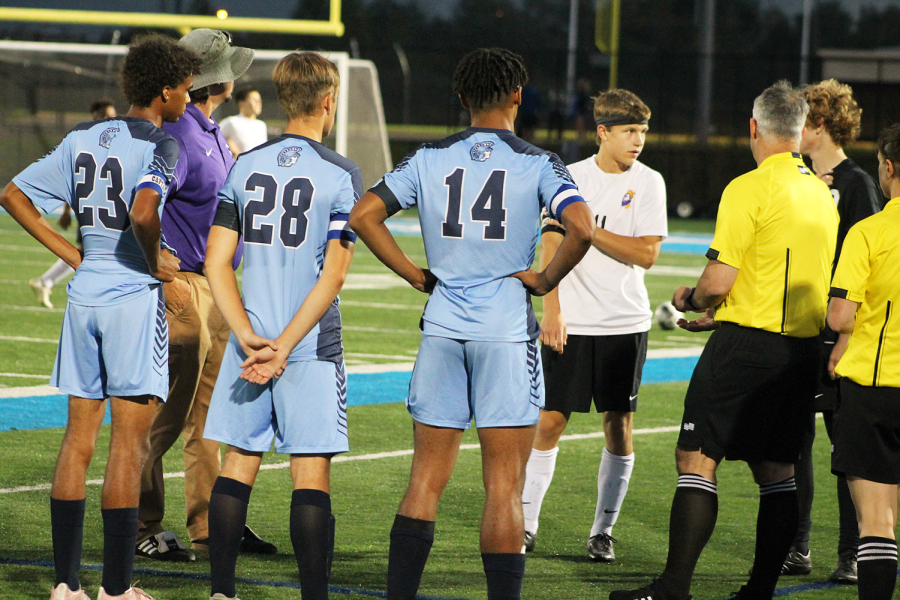 Soccer captains Darrel James, on the far right, Aaron Johnson, in the middle, and Diedrick Nikoi on the left, meet with the captains on the Cloquet soccer team on September 20, 2022. 