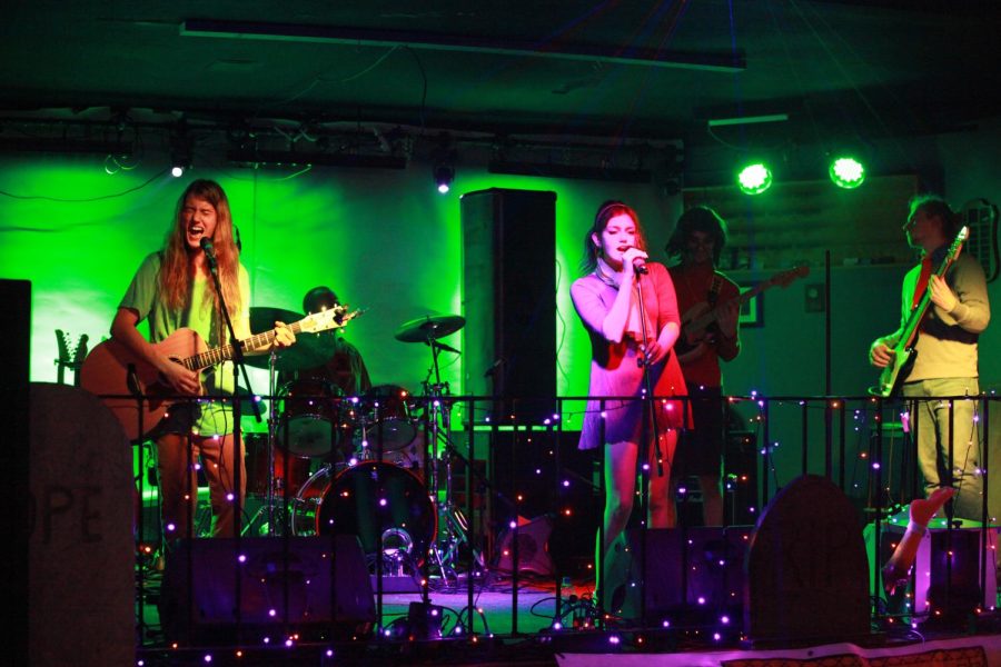 Born Too Late members Traxx Kavajecz (left), Rokkyn Kavajecz (middle), and Senior at Denfeld Taylor Shykes (right), performed with other performers Ian Hopp on drums and lead guitarist Emanuel Eisele (back right) at Top Hat Tavern Oct. 29. Each performer dressed as a character from Scooby Doo for this halloween themed event.