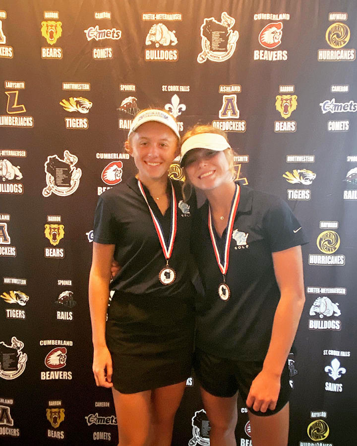 Junior Autumn Cooper (right) and sophomore Brynn Johnson (left) pose together after receiving rewards after making the all conference team on Sept. 20.