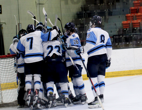 Varsity boys hockey celebrates at the end of the game a 7-0 win against Marshfield Tigers at Wessman arena Feb. 16, 2023.