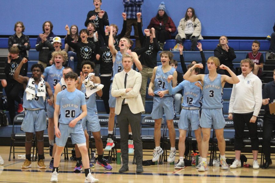 The boys basketball team all cheering after they win their first conference game of the season on Dec. 9, 2023 at the SHS main gym. 