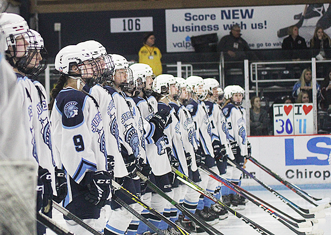 Girls hockey team on the line as they get announced at the beginning of the game. Mar. 2, 2023.