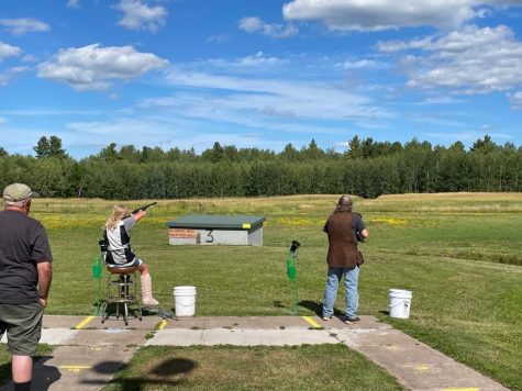 Abby Peterson shoots from a bar stool at Superior Trap & Gun Club, used while she recovered from a broken ankle.

