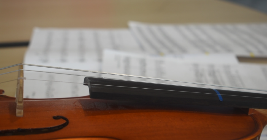  A violin and sheet music from an SMS orchestra performer lay on a table in the commons before the Solo and Ensemble festival on Tuesday, March 28, 2023. 
