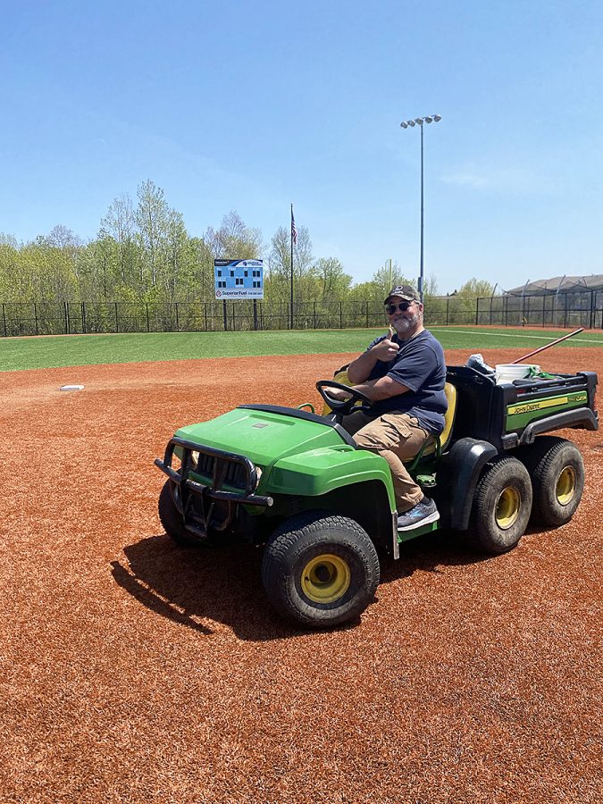 Cary Pallas drives his John deere gator on the NBC Spartan Sports Complex softball field after he groomes the pitchers mound on May 26, 2023 
