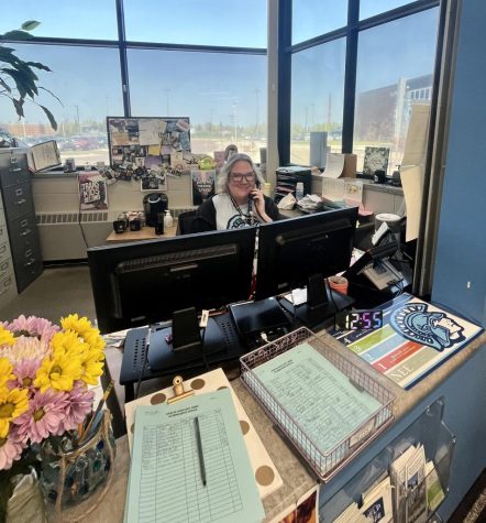 Elaine Holmberg poses at her desk, May 26 2023