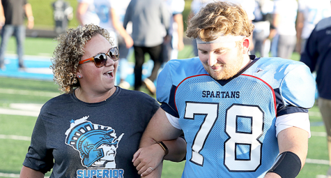 Nikkee Francisco chatting with football player Quinn Dahl on Sep. 13, 2019. They walk together as their names get called for teacher appreciation week.