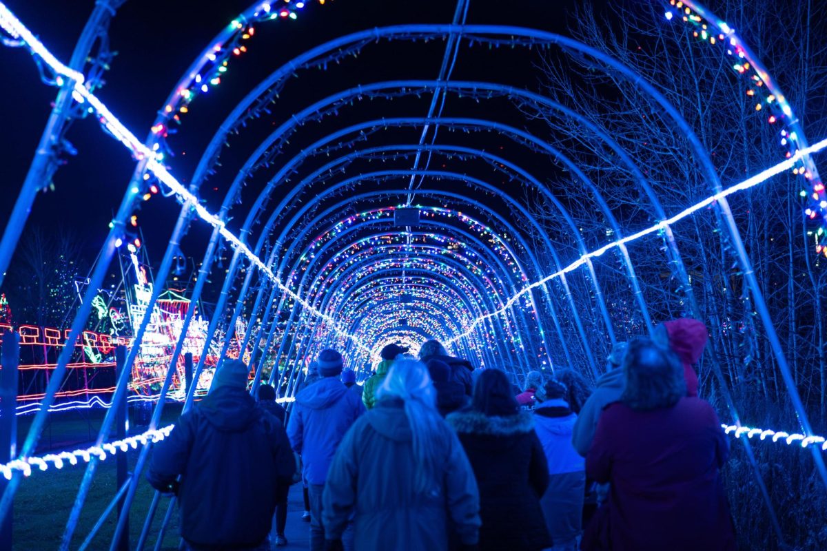 People walk under the christmas lights on opening night Nov. 18 at Bentleyville 
