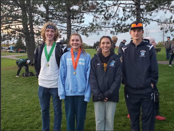 Runners lined up for a picture after awards, left to right,  Senior Jacob Lind,  Junior Tayler McMeekin, Sophomore Elena Almonte and Senior Jaden Karren. 