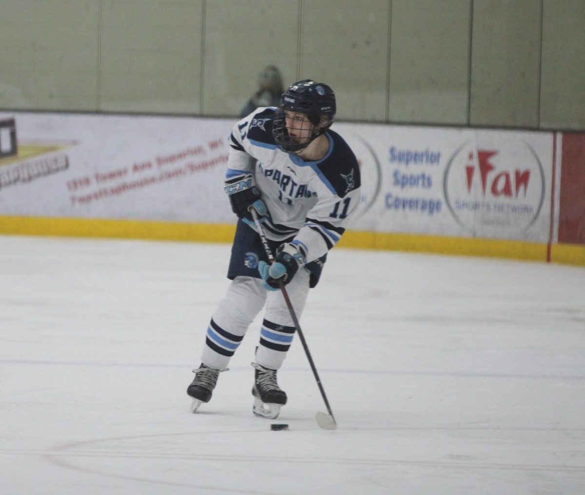 Sophomore forward Brady Haroldson skates down the ice for a chance to extend the lead against the Ashland Oredockers. Haroldson scored two goals in the game: one in the first period to tie the game up and one in the third period. 
