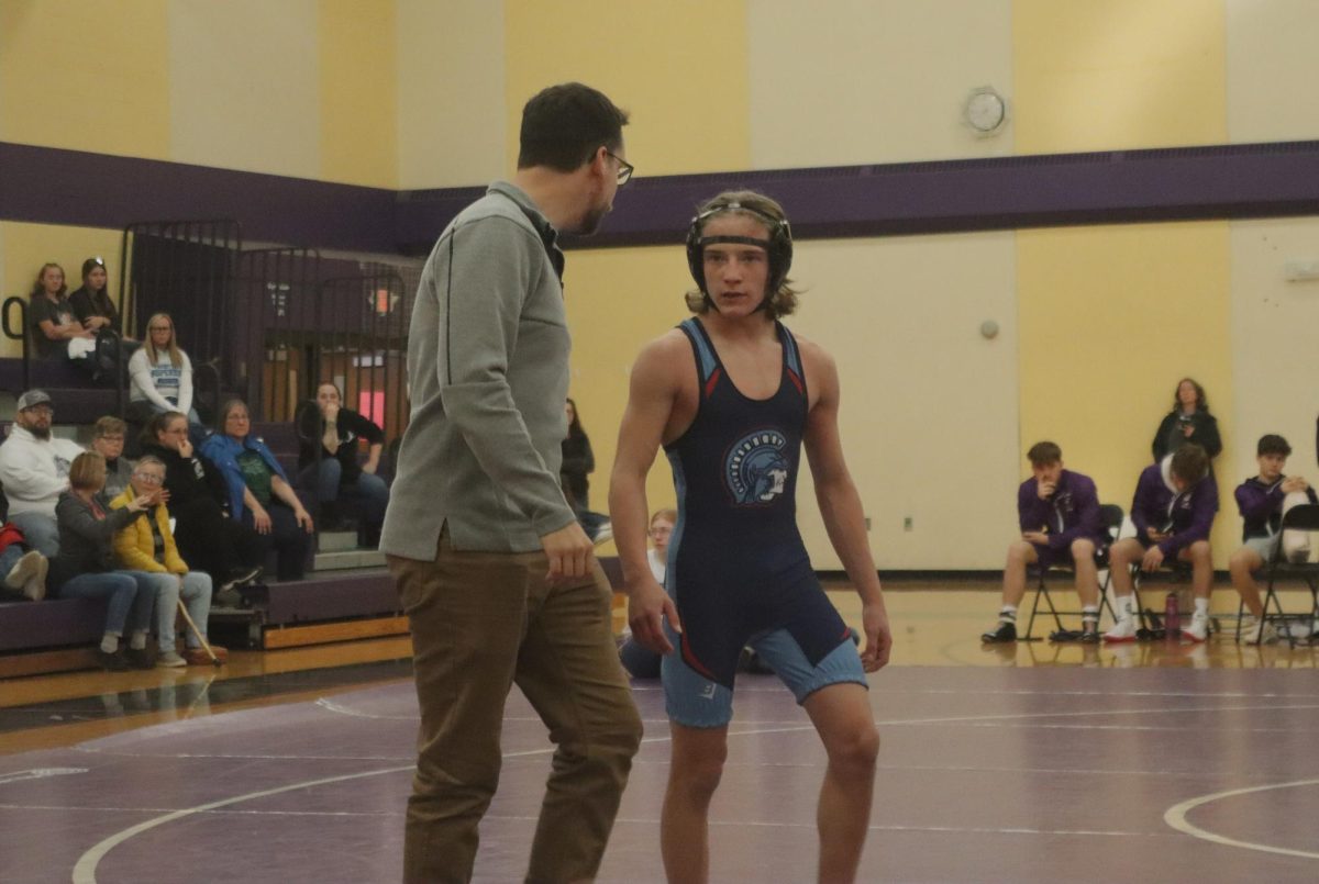 +Freshman+Versii+Kavajecz+discusses+his+match+with+head+coach+Nick+Long+on+Dec.+1%2C+2023+at+Cloquet.+Kavajecz+will+be+moving+on+to+the+sectional+tournament+on+Feb.+17.