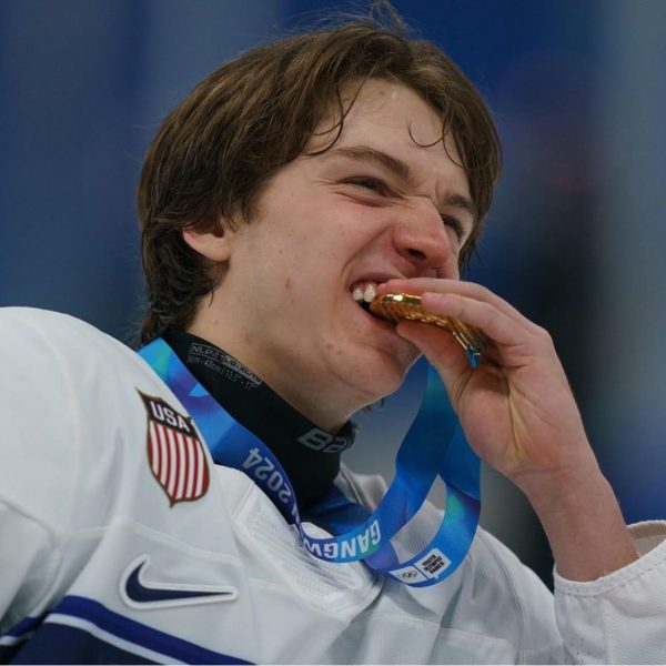 Sophomore defender Jackson Marthaler bites into his gold medal on Jan. 31, 2024 in Gangwon, South Korea. Marthaler won the championship game against Czechia to take first place in the Winter Youth Olympic Games.