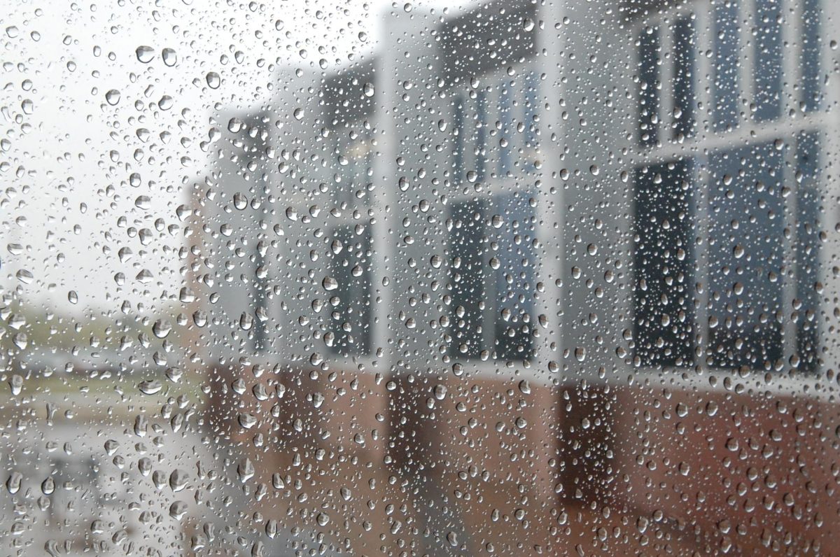 Water+droplets+fall+down+the+commons+window+May+16.+On+rainy+days%2C+a+grim+scene+is+set+outside+the+school+windows.++