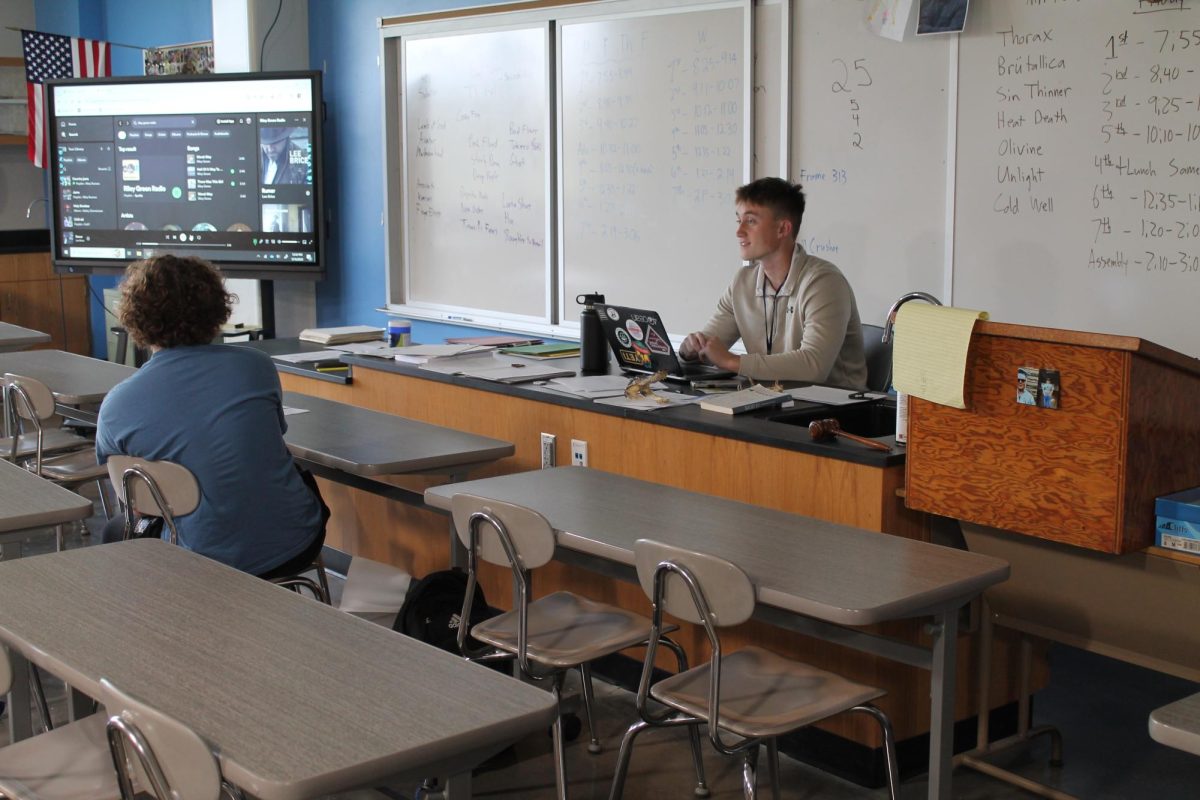 Taylor Burger (right) talks casually with Senior Caleb Geissler. (left) The two have a very enjoying conversation talking about how Geissler needs a haircut