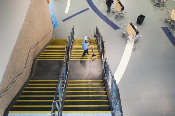 Engineer Bill Cockerham sweeps the main stairs in the commons on May 13, 2024.
