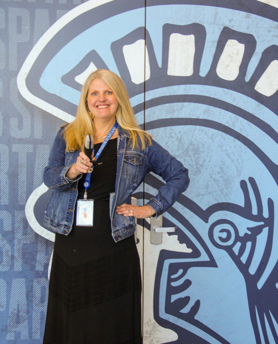 Assistant principal Kari Saunders poses with a microphone for a photo May 15, 2024. Saunders shows that students can have a voice. 
