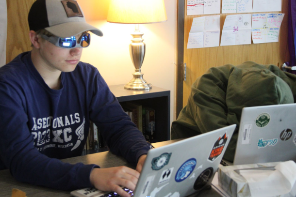 Sophomore Brendan Farrel (left) Copy Edits a new story for an up and coming print from the Spartan Spin Headquarters while Kaylee Larson (right) takes a quick snooze on the desk on May 16, 2024. The Spin Staff say this next print will be unlike any print they’ve ever done before (Photo Taken By Kieran Hutchins on May 16, 2024)
