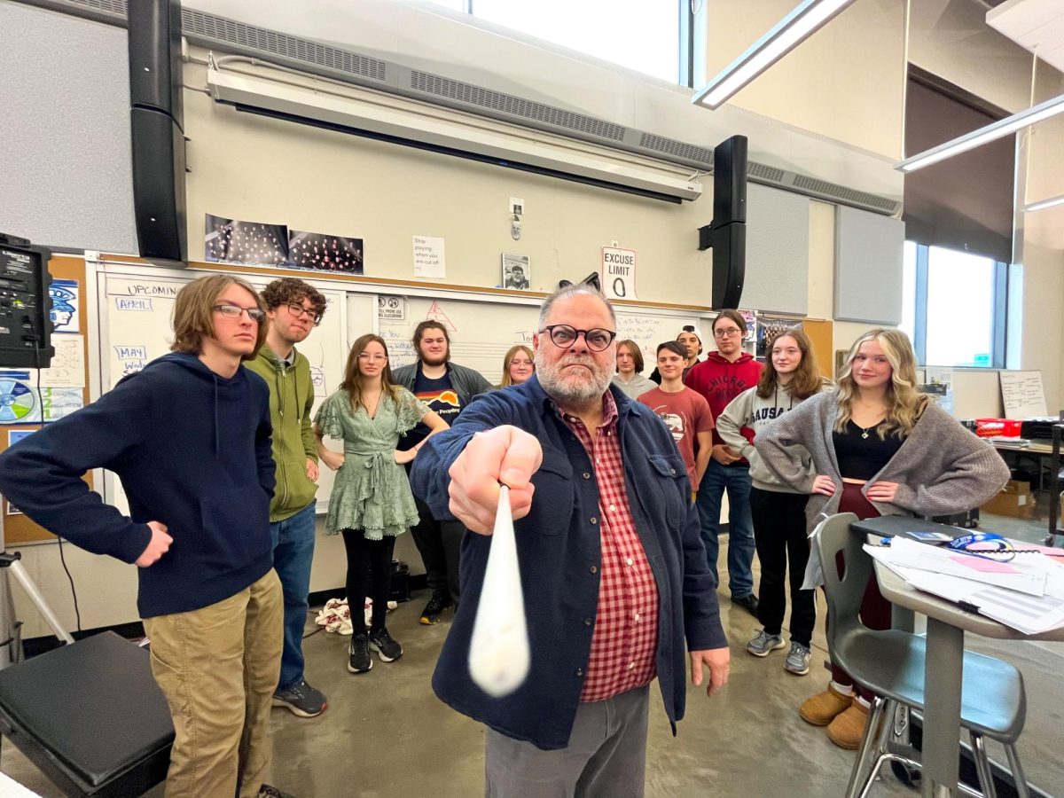 Director Daniel Eaton (center) scoldingly poses in the band room as student leaders and other various Concert Band members disapprovingly watch him on April 30, 2024. Eaton has strong relationships with his students and brings this goofy attitude to set the mood in his classes every day. 
