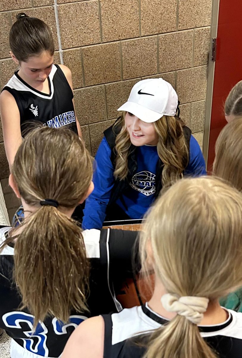 Eva Peterson speaks in a team huddle before her first game coaching her girls Playmakers team at Stillwater High School on April 22, 2024.