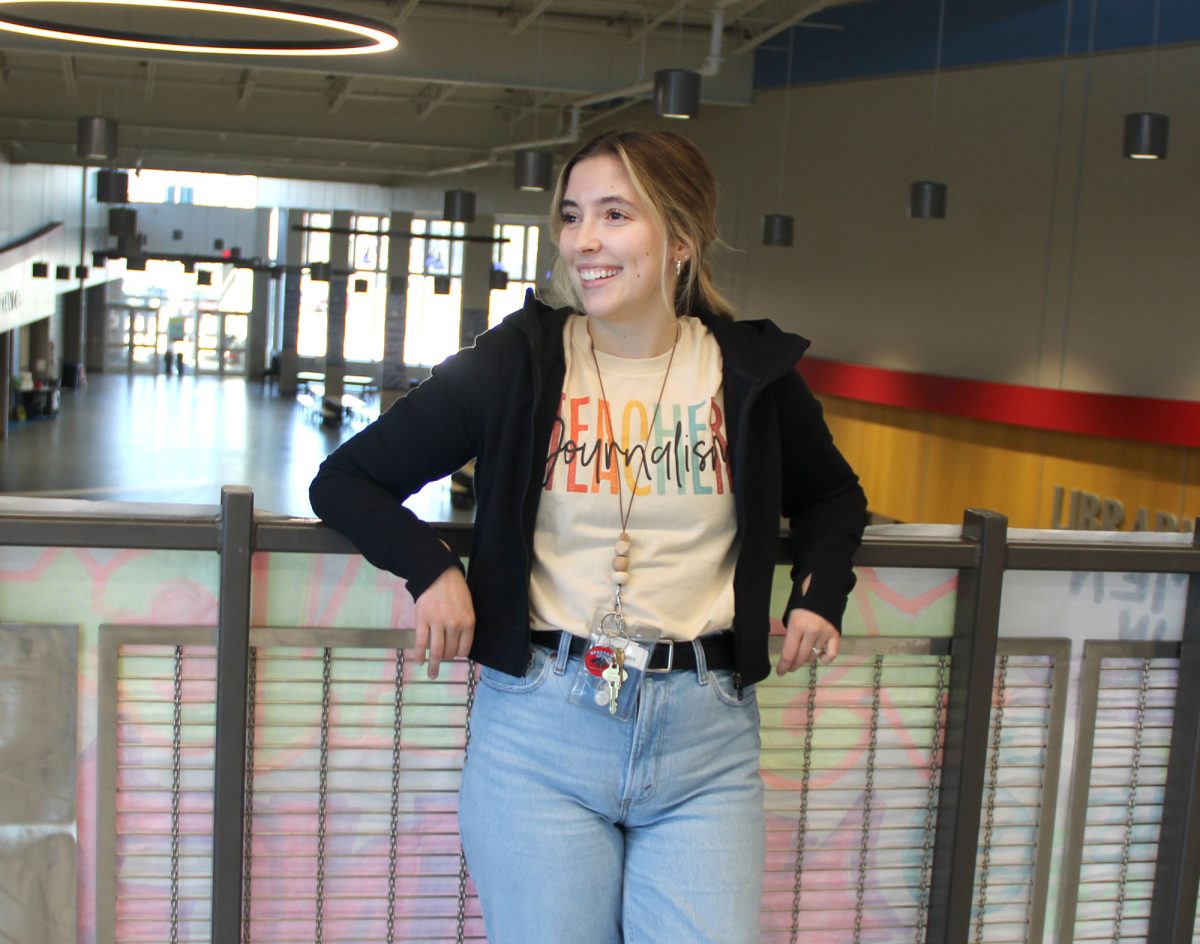 Spartan Spin teacher Elise Hintzman poses and talks to a person off camera while she flashes a smile on May 3, 2024. Her smile feels more genuine knowing that she was laughing, too. 