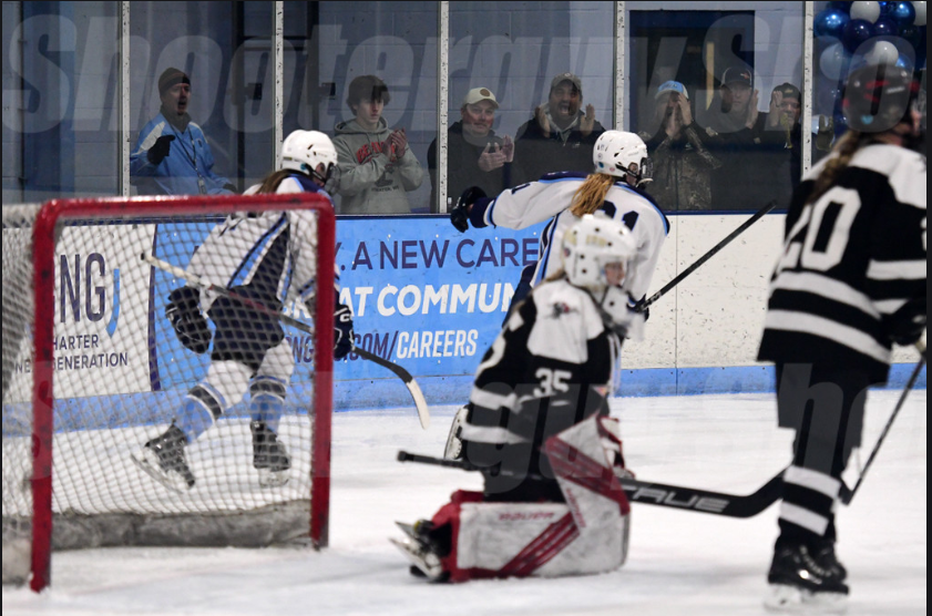  Dean Bryan Denninger (left) cheers as senior Autumn Cooper (right) scores a goal against Duluth Stars at SAHA on Jan 23, 2024. Denninger takes time to cheer on student athletes outside of the school day. 