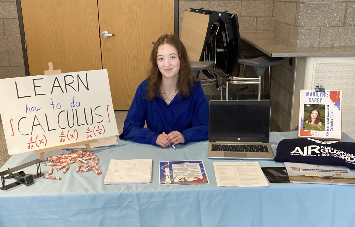 Senior Madilyn Carey presents her senior project in the cafeteria on May 2, 2024. Carey’s presentation included calculus tutoring for volunteer work and Air National Guard job shadowing. Carey will drop anything to lend a hand to someone in need whether its for calculus or just in general.   
