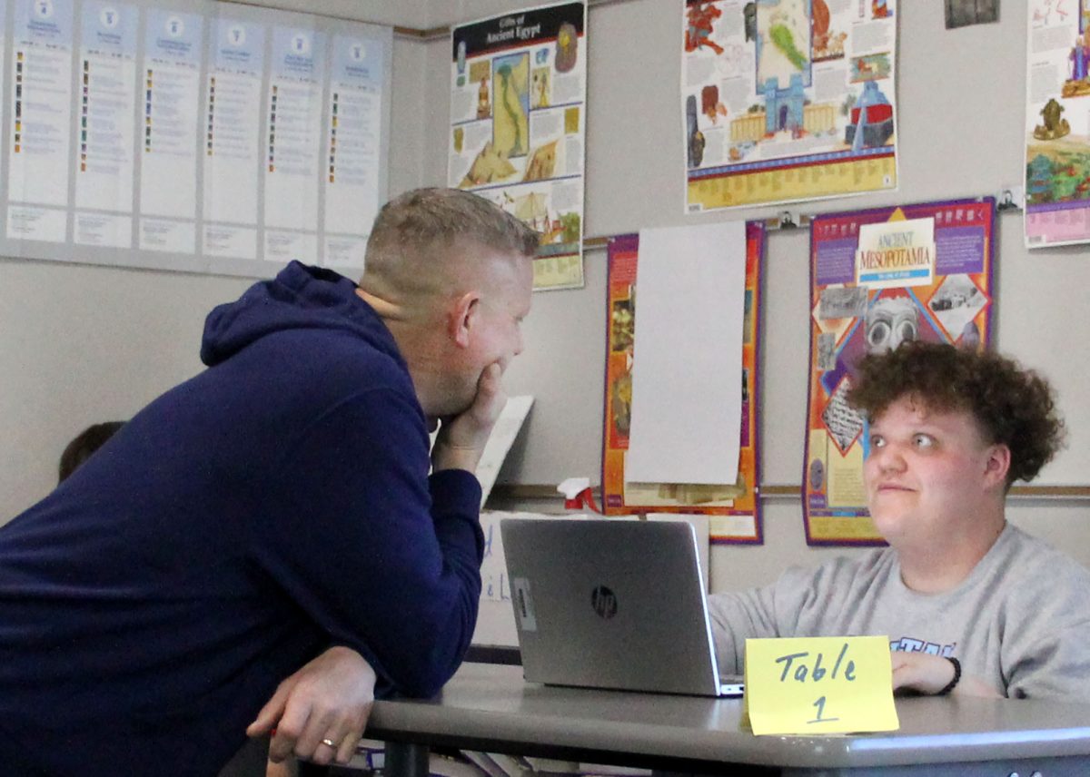 Coach Chad Postal chats with Sophomore Logan Pittsley in Postal’s classroom on May 3, 2024. Postal’s interactions form bonds with many students. 