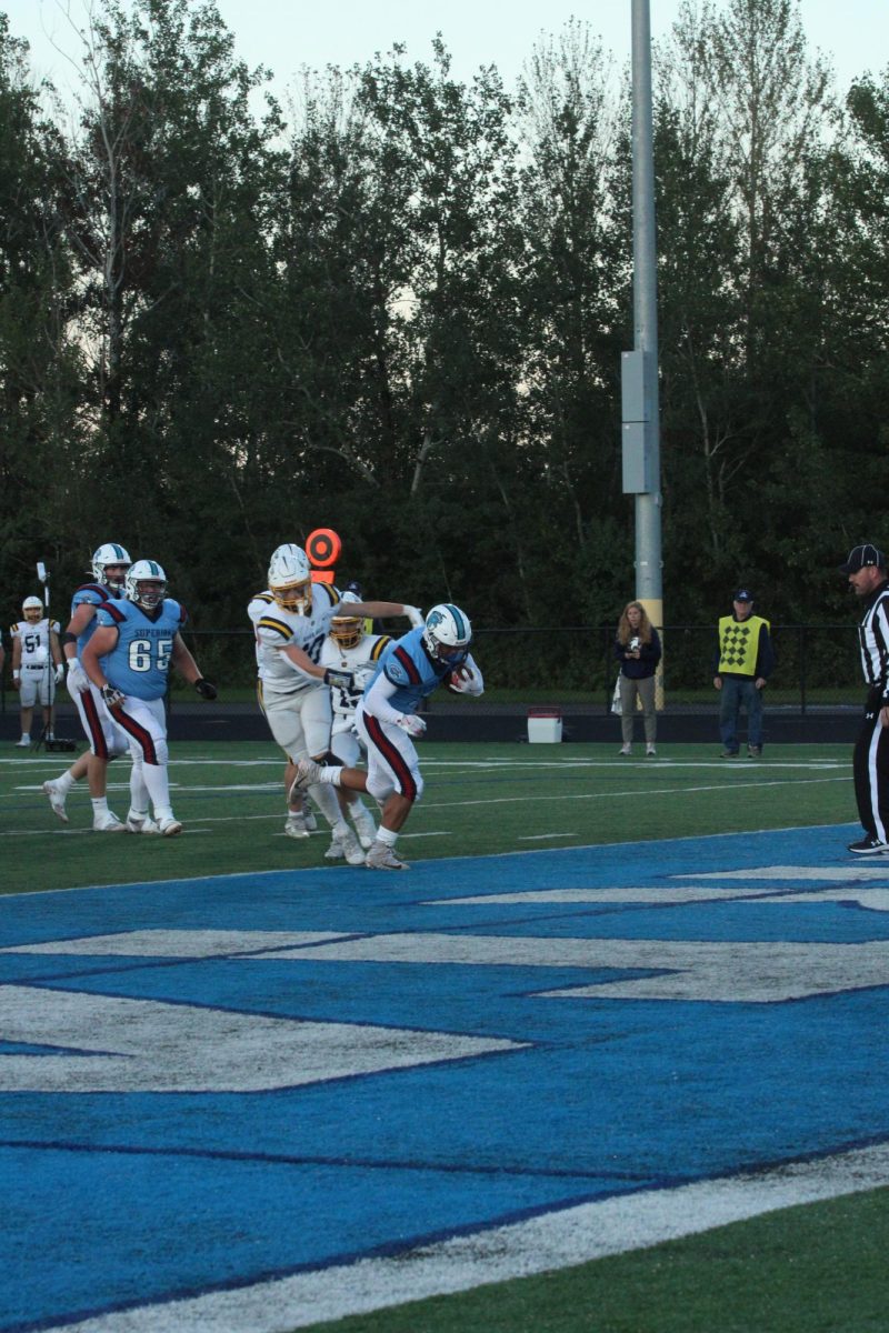 Junior running back Taynum Clark (3) runs the ball in for the first touchdown of the night on Sep. 6, 2024.