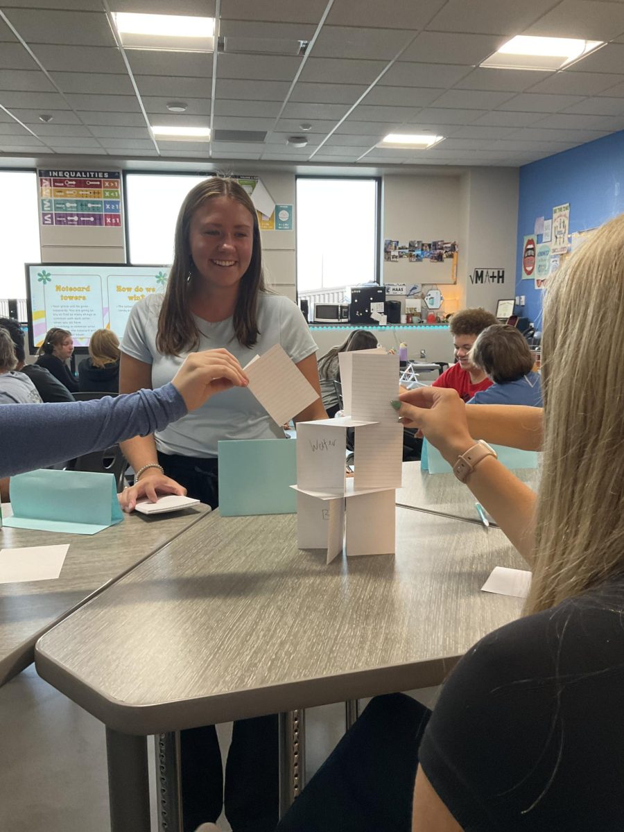 Math teacher Maddie Haas helps students with a warm up activity creating note card towers on Sept. 4, 2024. 