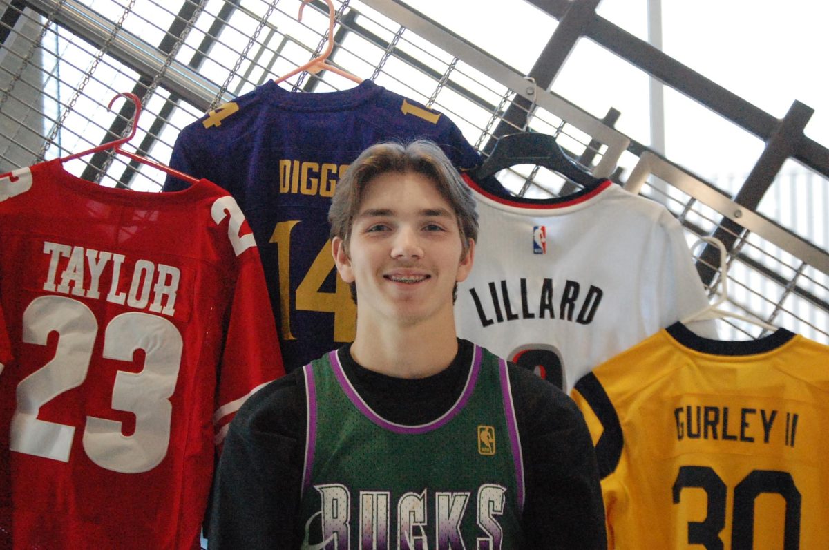  Junior Austin Edwards smiles in front of his favorite jerseys on the balcony of the second floor on Sept. 24.