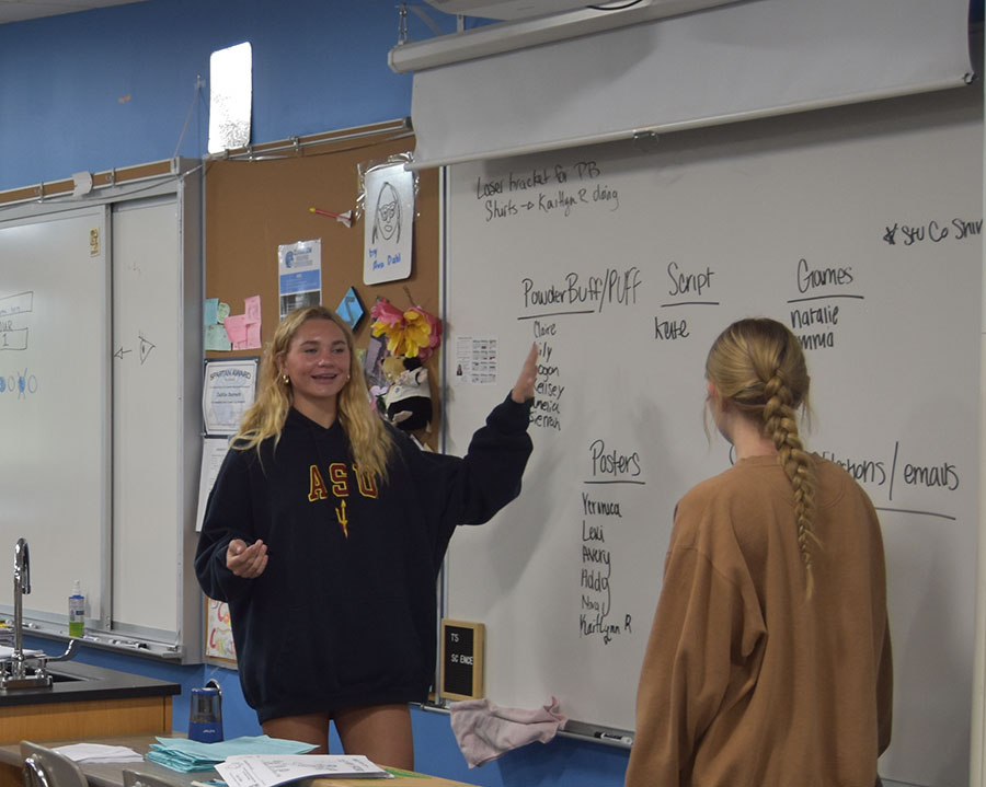 Seniors Taylor McMeekin (left) and Maggie Stenberg divide the members of the Student Council into groups for homecoming, Sept. 13.