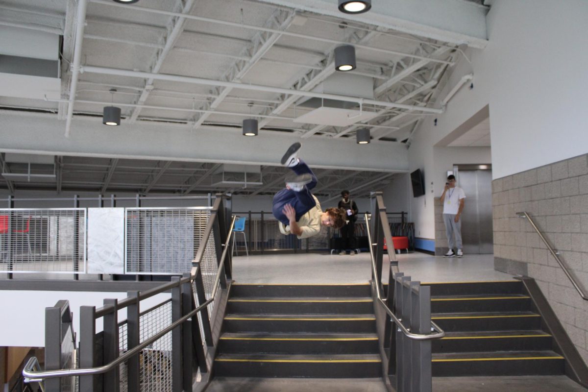 Junior Trenton Beron shows off his skills while doing a flip off the third floor stairs.