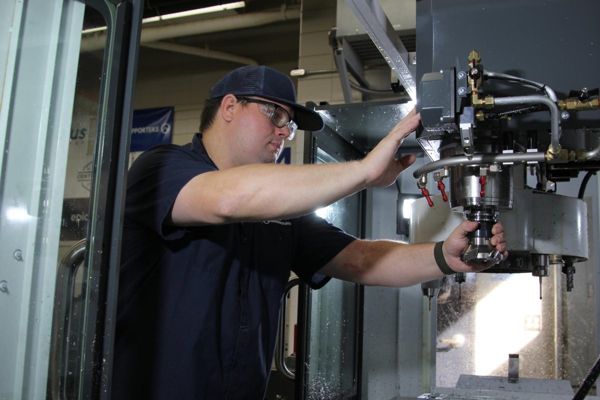 Tech-ed teacher Spike Gralewski changes the tooling on the HAAS CNC machine on Sept. 24 in the tech-ed wing. The machine was purchased through a Cenovus Energy grant over the summer of 2023.