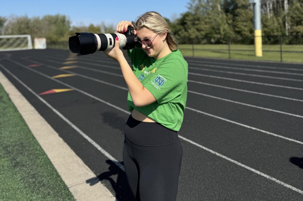 Senior Natalie Schultz takes a picture at a soccer game on Sept. 21 at the NBC Sports Complex. This is just one of the many teams and sports she shoots for.