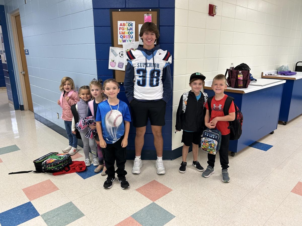 Junior Miles Morris (38) and six Bryant elementary school students pose for a picture after they finish eating on Oct. 3. (Submitted by Miles Morris)
