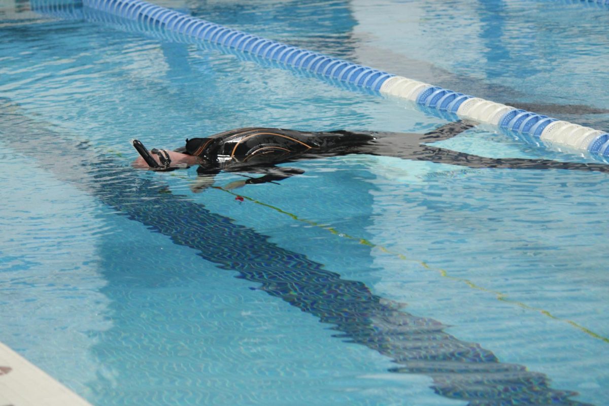 Firefighter floats during training on Monday, Oct. 21 in the Happy Tails Spartan Natatorium. 
