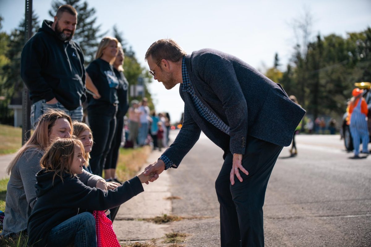 Mayor Jim Paine shakes the hand of a young student on the parade route on Oct. 4, 2024. (Submitted by Josiah Payne)
