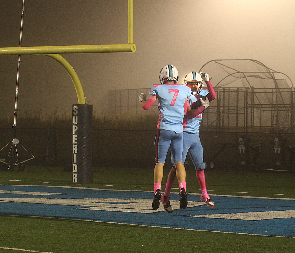  Juniors Aiden Parks (7) and Liam Flores (8) celebrate together on Sept. 13 after Flores scored a touchdown against Eau Claire North.