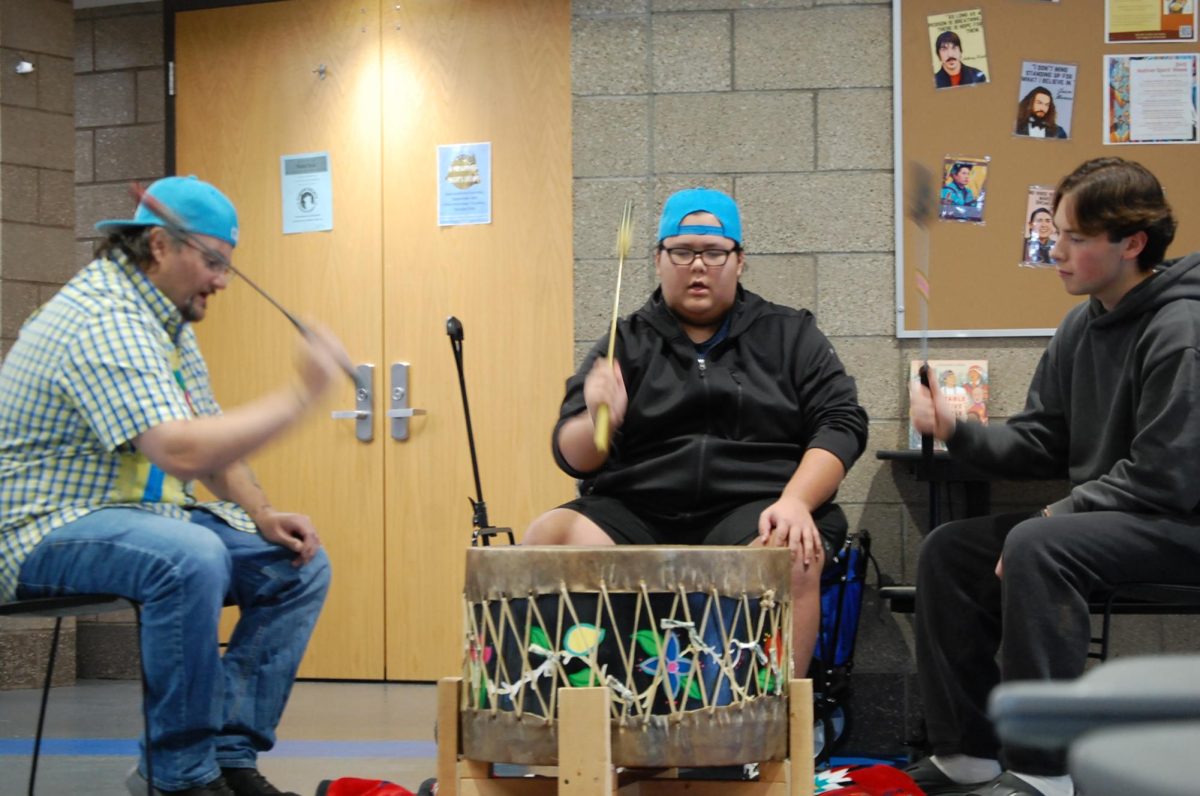 Junior Oso Fish participates in an Ojibwe drum circle with community members in the cafeteria on Nov 15. They played in order to teach people about Native American culture during Indigenous People's Week. 