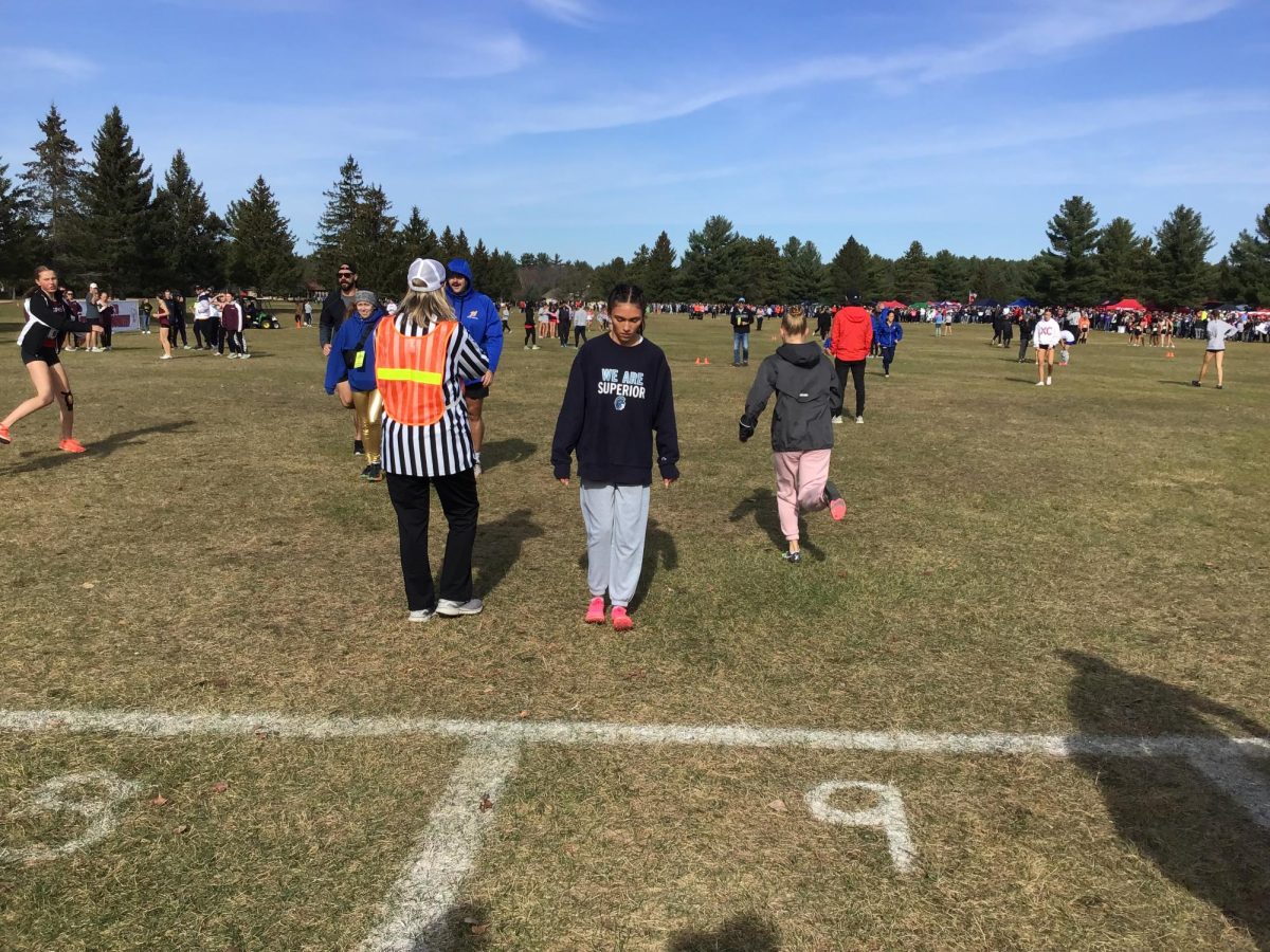 Junior Elena Almonte warms up before her race by doing heel walks. Almonte ran in the WIAA State Cross Country Championships on Saturday, Nov. 4, 2024.
