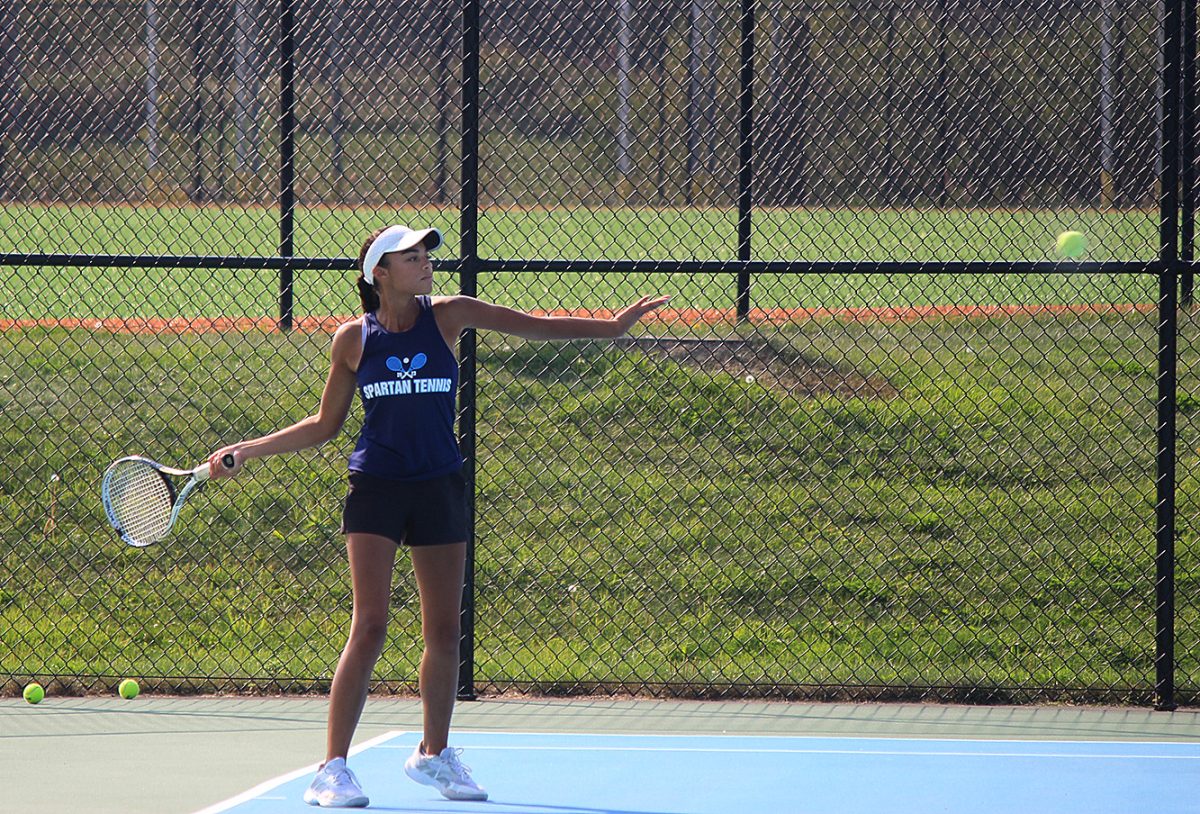  Senior Annika Nikoi begins to swing at a ball at No. 3 singles against Hermantown on Wednesday, Sept. 11. 
