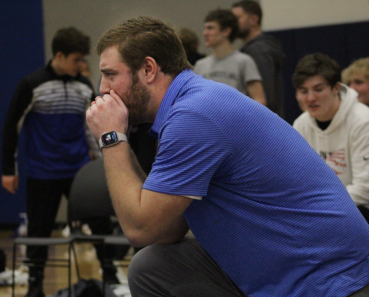 Coach Drew Hennessey shouts move suggestions for his wrestler at the Spartan’s home opener in the auxiliary gym on Dec. 5, 2024
