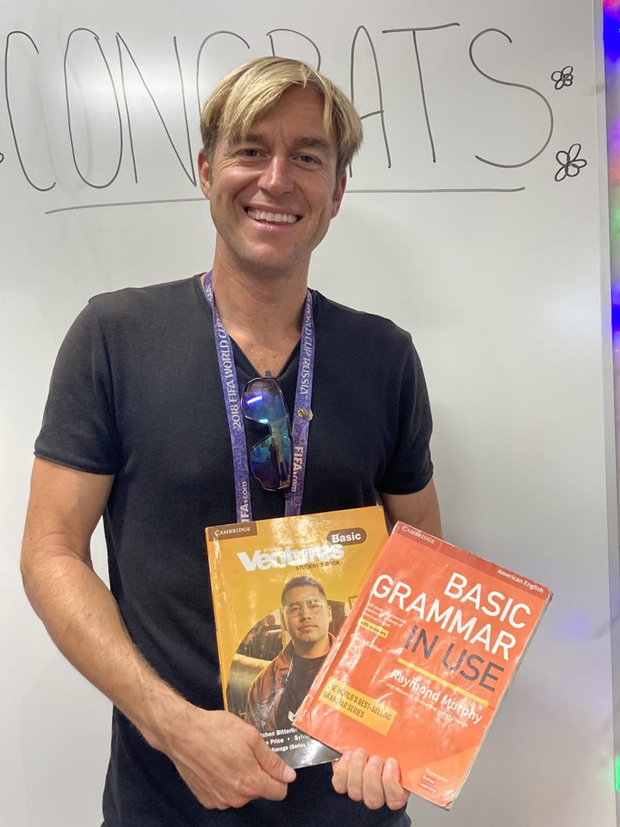 English as a second language (ESL) teacher Christopher Pascone stands by a white board holding his teaching materials on Sept. 17, 2024.