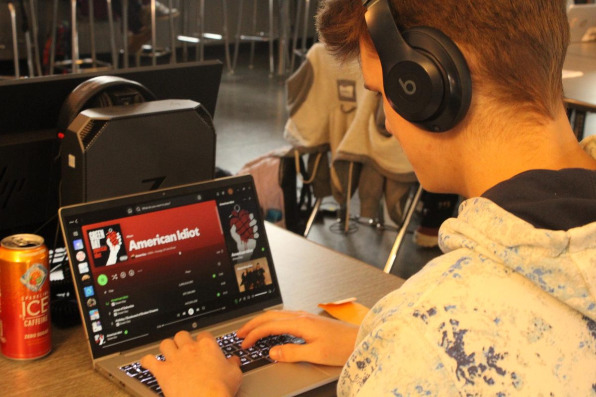 Senior Zander Scott listens to Green Day’s ‘American Idiot’ album while in class. It is a favorite of his, adding it to many of his playlists. 
