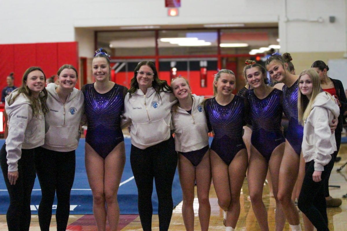 The Spartan gymnastics team, from left, Addison Matushak, Adelin Golat, Lauren Heintz, coach Hallee Ballavance, Avery Waletzco, Doris Ewald, Lillian Hoeffling, Lacey Skogland, Olivia Quam, pose for a photo at their first meet in Chippewa Falls on Dec. 14th. 
