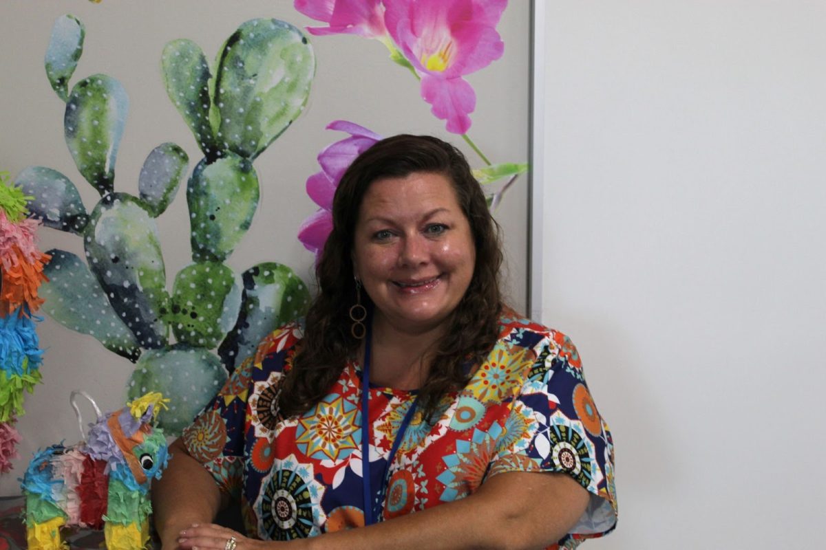 Spanish teacher Allison Conley smiles in her classroom next to her piñata  Sept. 15
