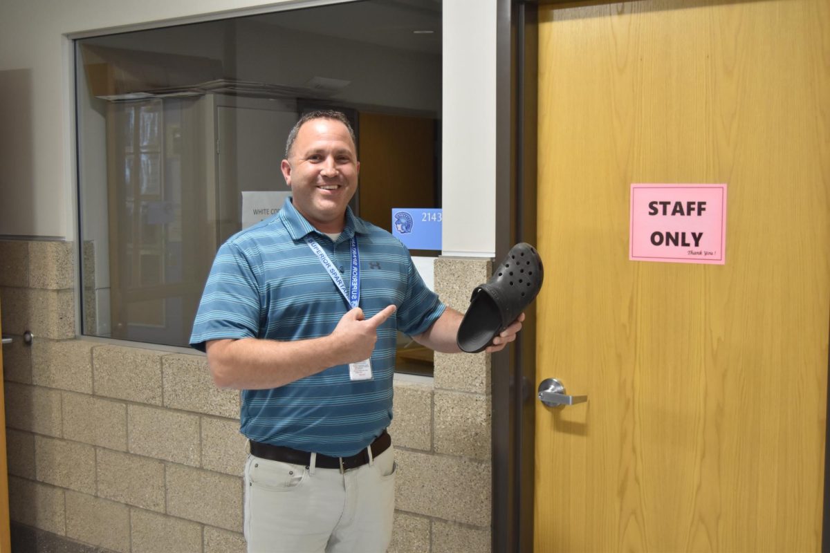  Math teacher Brent Hipp poses outside of his geometry class on “Crocin’ Thursday” with his classic black croc. 
