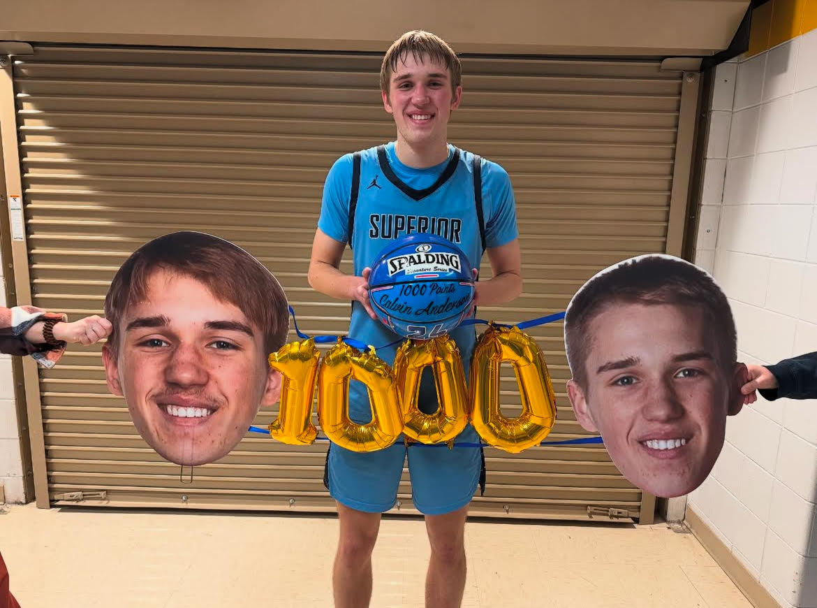 Junior Calvin Anderson poses after the game with his commemorative 1,000 point basketball on Jan. 28. Anderson is the third Spartan to reach this achievement. 
Submitted by Calvin Anderson