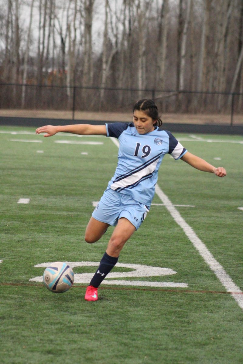 Senior Ava Gudowski runs down the field to gain possession of the ball against the Hudson Raiders at the NBC Sports Complex on April 10, 2025. 