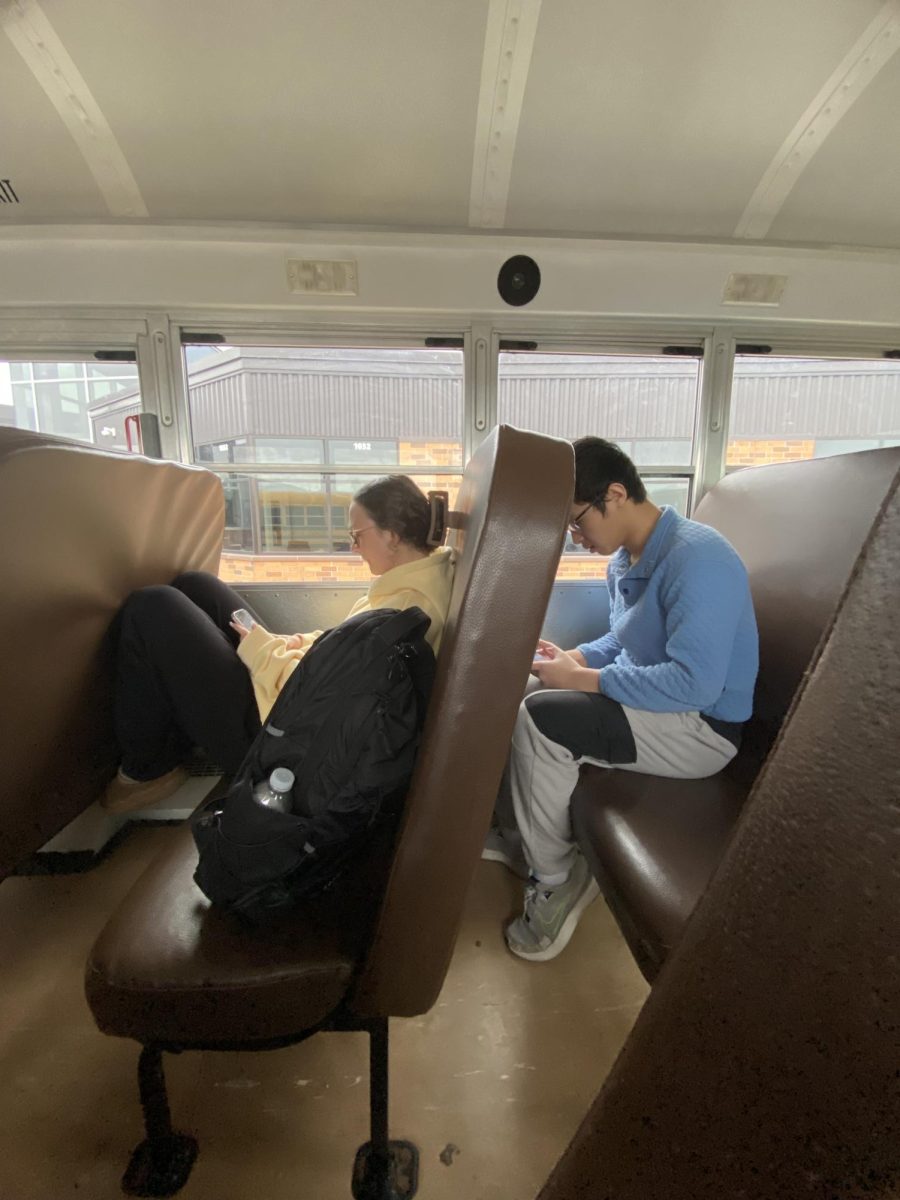 Juniors Rilee Edquist and Phong Hoang wind down on the bus after a whole day field trip to Ashland on April 25, 2025.